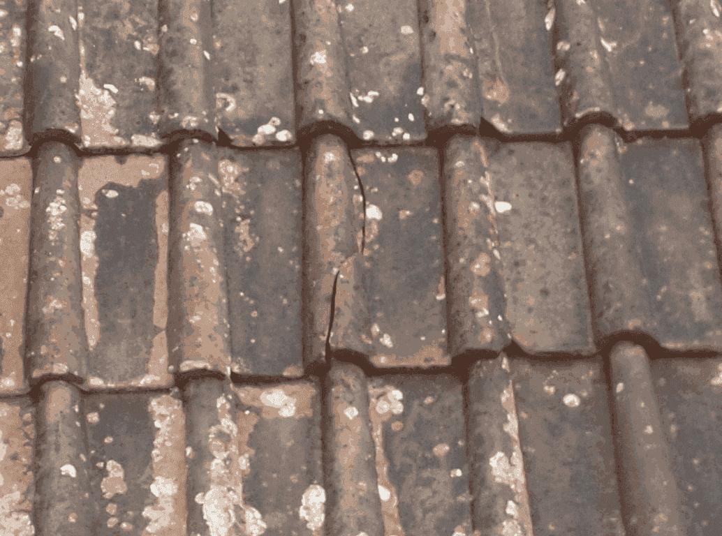 Old weathered roof tiles before repair